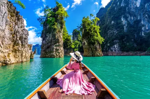 Lady with pink dress on a boat in paradise