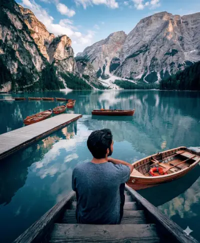 Man sitting on the stairs of a dock